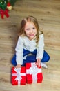 Happy little smiling girl with christmas gift box. View from abo Royalty Free Stock Photo