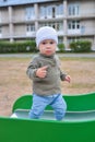 Happy little toddler boy having fun sliding on playground Royalty Free Stock Photo