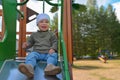 Happy little toddler boy having fun sliding on playground Royalty Free Stock Photo