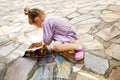 Happy little toddler girl drawing with colorful chalks on ground or asphalt in summer. Excited child having fun with Royalty Free Stock Photo