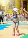 Happy little toddler girl playing through a fountain Royalty Free Stock Photo