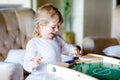 Happy little toddler girl playing table soccer with family at home. Smiling child winning board football, indoors Royalty Free Stock Photo