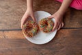 Chocolate donuts in girls hands. Royalty Free Stock Photo