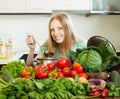 Happy long-haired woman cooking with heap of vegetables Royalty Free Stock Photo