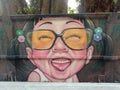 Happy looking girl with glasses graffiti in Bangkok Thailand
