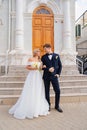 happy and in love bride and groom at the steps of the building in retro style. Royalty Free Stock Photo