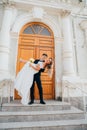 happy and in love bride and groom at the steps of the building in retro style. Royalty Free Stock Photo