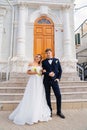 happy and in love bride and groom at the steps of the building in retro style. Royalty Free Stock Photo