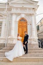 happy and in love bride and groom at the steps of the building in retro style. Royalty Free Stock Photo