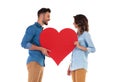 Happy in love couple holding big red heart Royalty Free Stock Photo