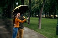 Happy love couple leisures in park, rainy day Royalty Free Stock Photo