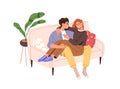 Happy love couple relaxing together, sitting on sofa at home. Young romantic man and woman hugging, laughing, resting on