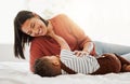 Happy, love and family time with a mother and son being playful and bonding on a bed at home. Parent playing with her Royalty Free Stock Photo