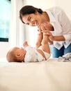 Happy, love and a mama with her baby in the bedroom of their home together for playful bonding. Family, children and a Royalty Free Stock Photo
