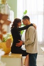 happy and in love man and pregnant woman in black dress. Royalty Free Stock Photo