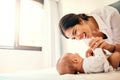 Happy, love and a mother with her baby in the bedroom of their home together for playful bonding. Family, children and a Royalty Free Stock Photo