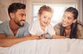 Happy, love and parents with their baby on bed in the bedroom bonding, playing and relaxing at home. Happiness, smile Royalty Free Stock Photo