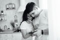 Happy loved couple are making the selfie with red apple in their new wooden kitchen. Royalty Free Stock Photo