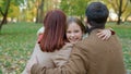 Happy lovely adorable cute girl child kid daughter run hurry rush running to parents mother father at park outdoors in Royalty Free Stock Photo