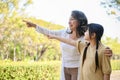 Happy and lovely Asian granddaughter having a great time with her grandmother in the park Royalty Free Stock Photo