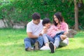 Happy lovely beautiful Asian family father, mother and son playing together at home garden. Smiling parent and cheerful kid relax Royalty Free Stock Photo