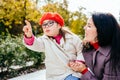 Happy lovely mother carrying little daughter with special needs in eyeglasses. Cute curious girl pointing finger in Royalty Free Stock Photo