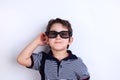 Happy lovely smiling boy in sunglasses, studio shoot on white. C Royalty Free Stock Photo