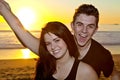 Happy Lovers on the Beach at Sunset