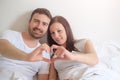 Happy lovers couple feeling comfortable lying in bed Royalty Free Stock Photo