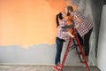 Happy lovers couple are repair in renovation, improvement of room and kissing preparing to move to new house Royalty Free Stock Photo