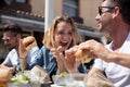 happy lovers eating burgers outdoors