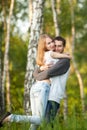 Happy lovers hugging in the birch grove