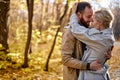 Happy lovers hugging at park. Cute caucasian couple in love embracing during date. Royalty Free Stock Photo