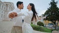 Happy lovers spinning street closeup. Latina couple holding hands laughing date