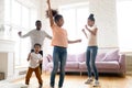 Happy loving african american family dancing to favorite song. Royalty Free Stock Photo