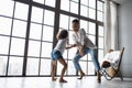 Happy loving afro american family. Young mother and her daughter playing in the nursery. Mom and daughter are dancing on the Royalty Free Stock Photo