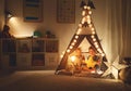 Happy loving children brother and sister play in dark tent in playroom at home Royalty Free Stock Photo