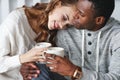 Happy loving couple drinking cocoa on winter morning in bed Royalty Free Stock Photo
