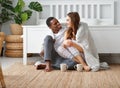 Happy loving couple drinking cocoa on winter morning in bed Royalty Free Stock Photo