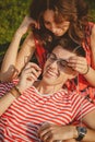 Happy loving couple with earphones listening to music from a smartphone and embracing outdoors summertime Royalty Free Stock Photo