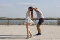 Happy loving couple embracing and kissing outdoors at summertime under blue sky. Love story. Couple in love. Sea background. Royalty Free Stock Photo