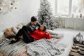 Happy loving couple enjoying Christmas having fun together on comfortable bed Royalty Free Stock Photo