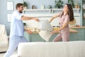 Happy loving couple having fun while having a pillow fight in the living room Royalty Free Stock Photo