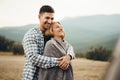 Happy loving couple hiking and hugging in mountains Royalty Free Stock Photo