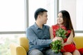 Happy loving couple. husband gives his a wife flowers at home