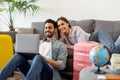 Happy loving couple planning trip after quarantine, buying low price tickets and booking hotel online, using laptop Royalty Free Stock Photo