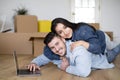 Happy Loving Couple Relaxing With Laptop After Moving Home Royalty Free Stock Photo