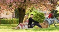 Happy loving couple relaxing in park with food. Enjoying their perfect date. Couple in love picnic date. Spring weekend Royalty Free Stock Photo