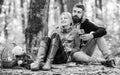 Happy loving couple relaxing in park together. Romantic picnic with wine in forest. Couple in love celebrate anniversary Royalty Free Stock Photo