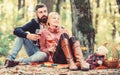 Happy loving couple relaxing in park together. Romantic picnic with wine in forest. Couple in love celebrate anniversary Royalty Free Stock Photo